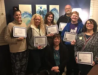 A group of team with certificates on the hand